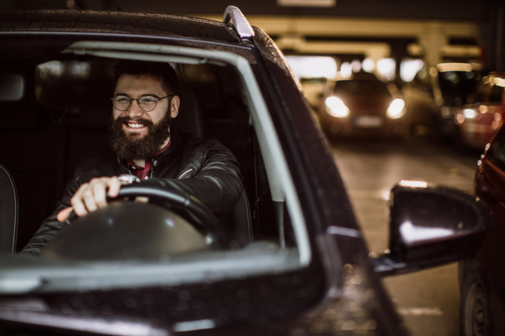 Man in car at a parking lot