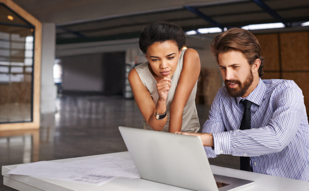 Businessman and woman looking at computer.